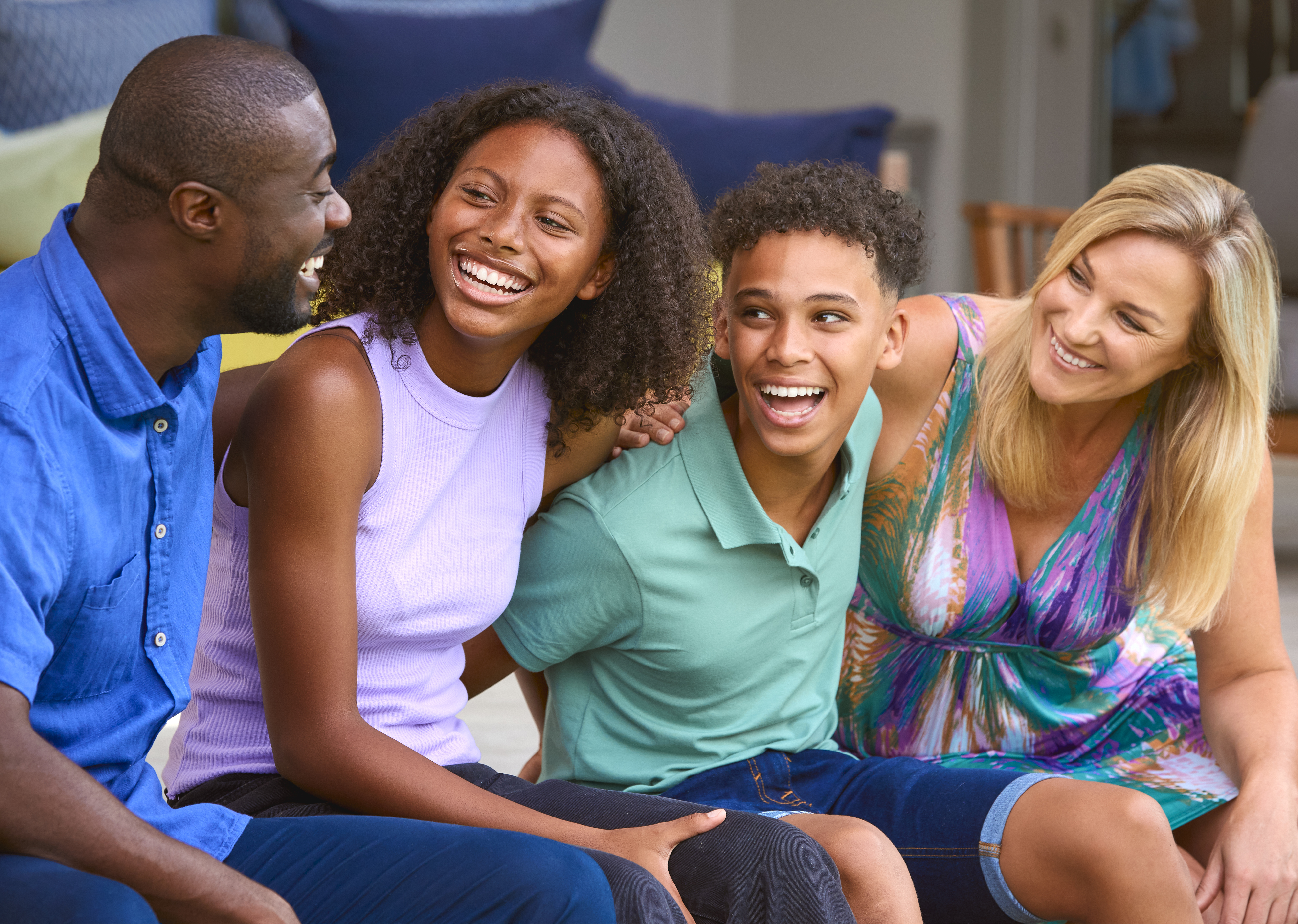 mother and father with two smiling children