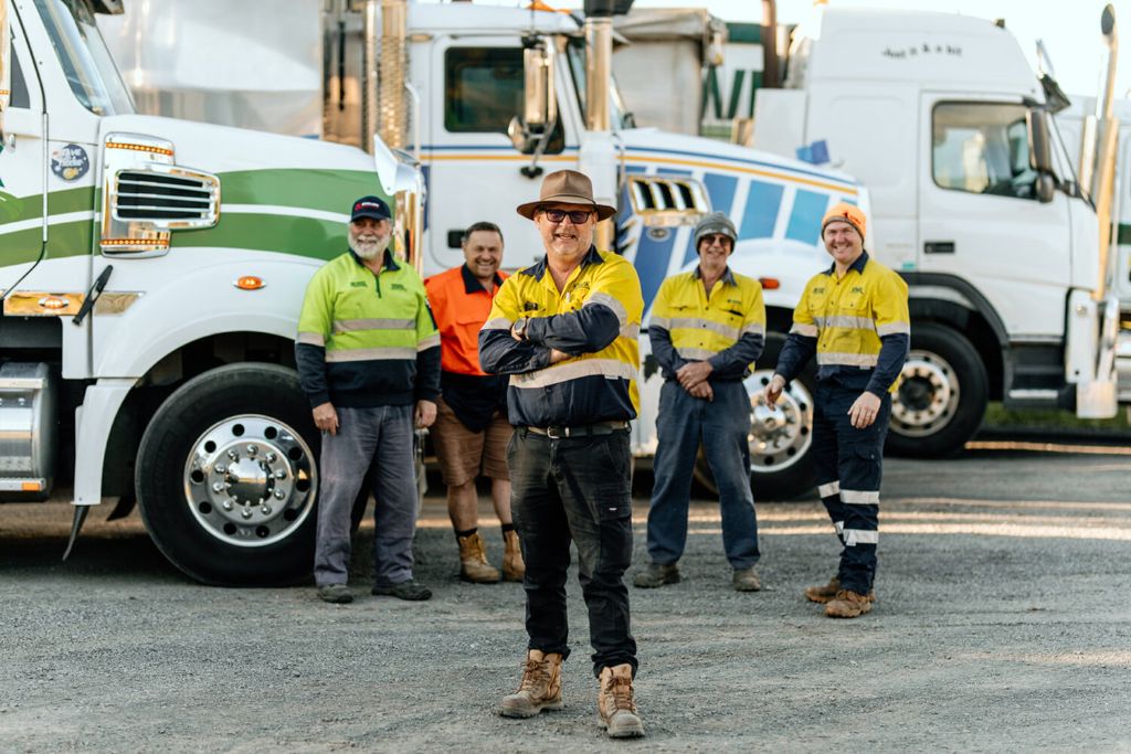Meridian truck drivers and crew standing in front of semi-trucks, representing workplace safety and the importance of professional reasonable suspicion drug and alcohol testing in the Treasure Valley.