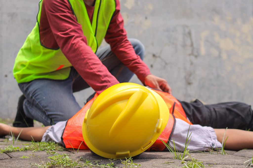 Construction worker injured at a job site, illustrating the importance of workplace safety and testing programs.